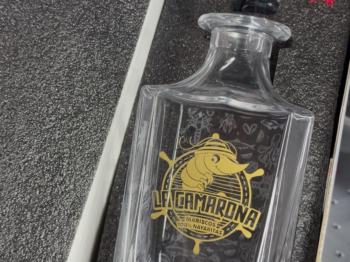 Crystal decanter with a gold-filled laser engraved emblem in a presentation box